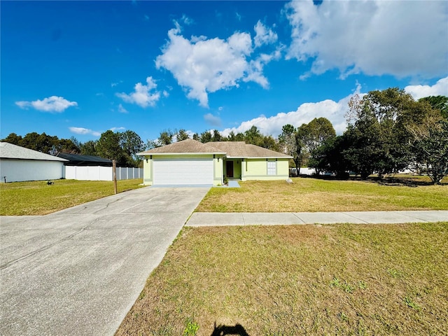 single story home with a garage and a front lawn