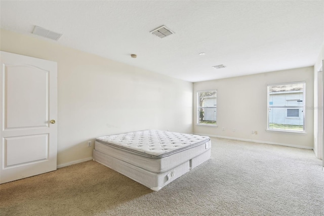 unfurnished bedroom featuring light carpet