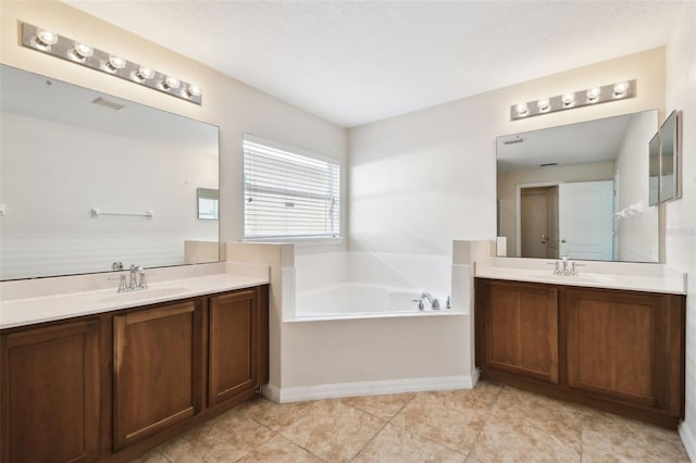 bathroom featuring vanity, a tub to relax in, and tile patterned floors