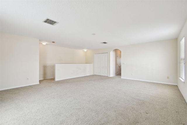 spare room featuring light colored carpet