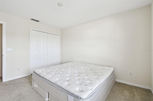 carpeted bedroom with a closet