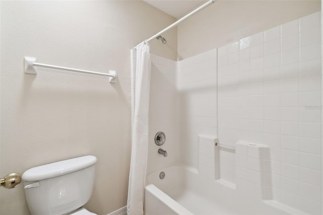 bathroom featuring shower / bath combination with curtain and toilet