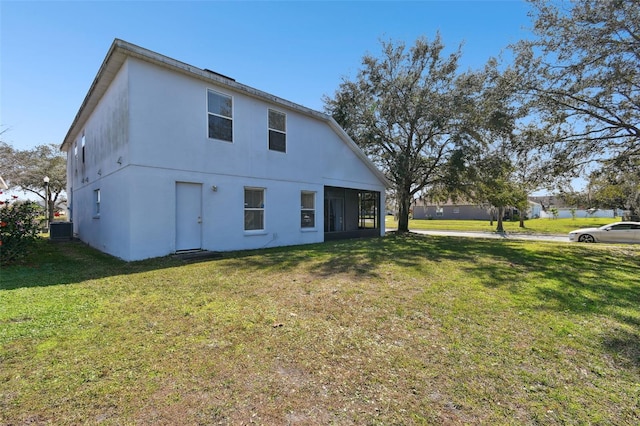 exterior space featuring a lawn and central air condition unit