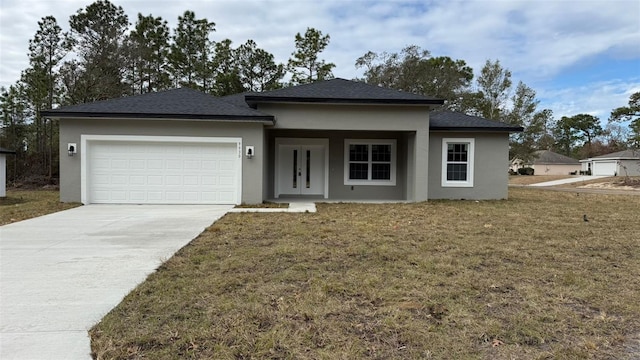 prairie-style house featuring a garage and a front yard