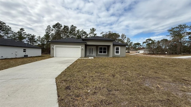 view of front facade with a garage and a front lawn