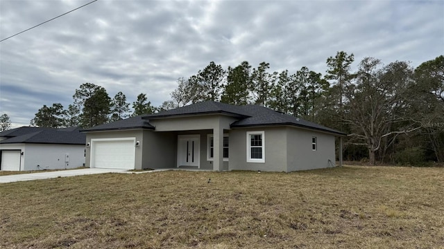 prairie-style home with a garage and a front lawn