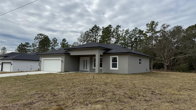 prairie-style house featuring a garage and a front lawn