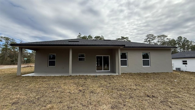 back of house featuring a yard, a patio, and central air condition unit