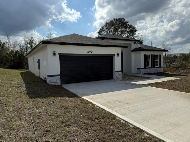 view of front of home with roof with shingles, stucco siding, concrete driveway, a garage, and stone siding