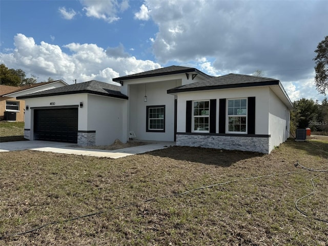 view of front of property featuring stucco siding, stone siding, and an attached garage