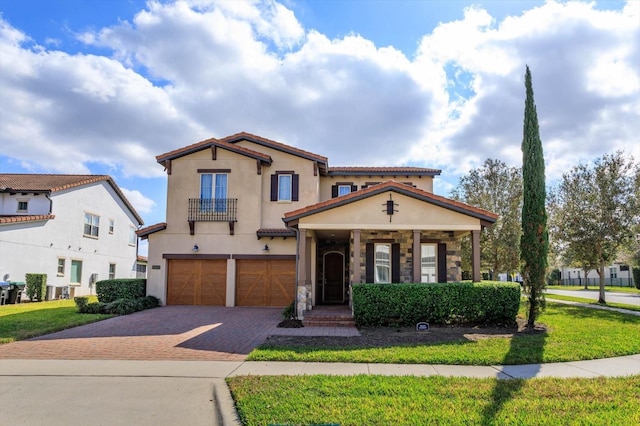 mediterranean / spanish-style house with a garage and a front lawn