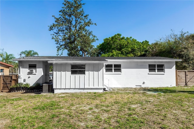 5508 Meridian Way, Orlando, FL 32808 - rear view of property with fence, board and batten siding, a lawn, cooling unit, and concrete block siding