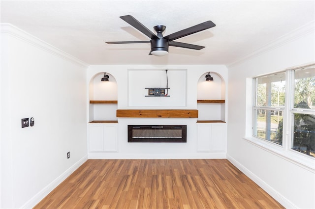 5508 Meridian Way, Orlando, FL 32808 - unfurnished living room featuring light wood-type flooring, crown molding, ceiling fan, and a glass covered fireplace