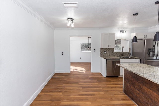 5508 Meridian Way, Orlando, FL 32808 - kitchen featuring crown molding, tasteful backsplash, dark wood finished floors, stainless steel appliances, and visible vents