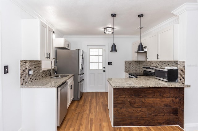 5508 Meridian Way, Orlando, FL 32808 - kitchen featuring crown molding, light stone countertops, appliances with stainless steel finishes, white cabinetry, and light wood-style floors