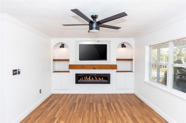 5508 Meridian Way, Orlando, FL 32808 - unfurnished living room featuring a ceiling fan, a warm lit fireplace, light wood-style flooring, built in features, and baseboards