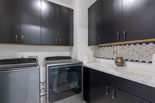 washroom with cabinet space and independent washer and dryer