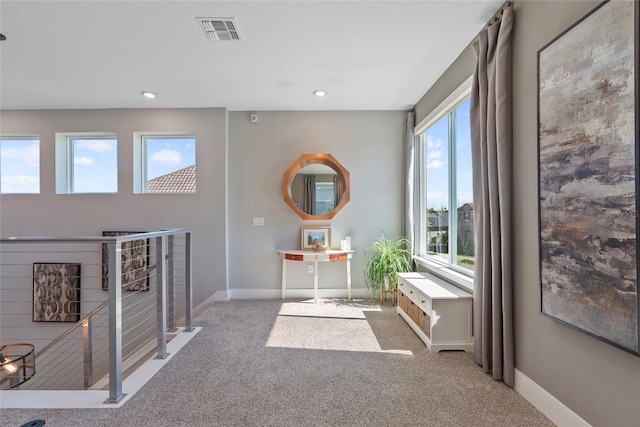 interior space featuring recessed lighting, carpet, visible vents, and baseboards