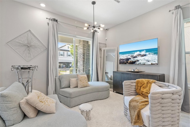 sitting room featuring a chandelier and recessed lighting