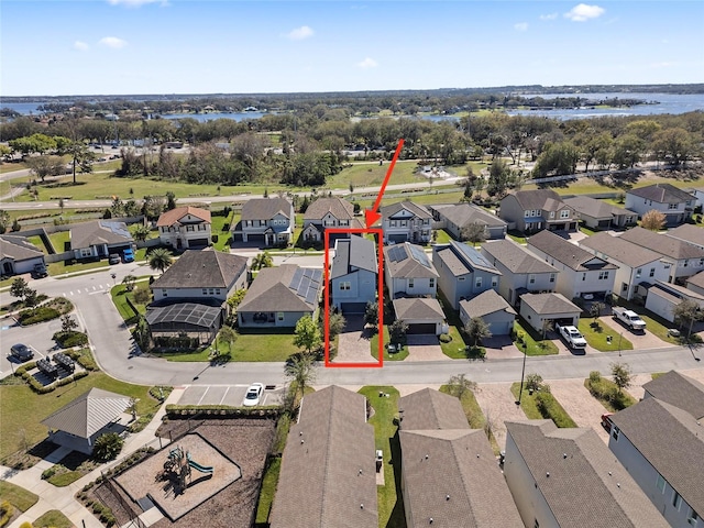 drone / aerial view featuring a water view and a residential view