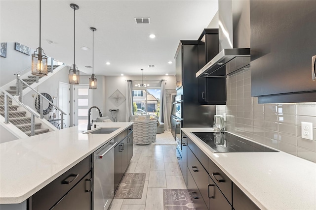 kitchen featuring dishwasher, a spacious island, wall chimney exhaust hood, decorative light fixtures, and black electric cooktop