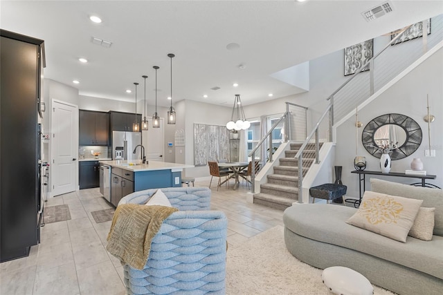 living room featuring stairs, an inviting chandelier, visible vents, and recessed lighting