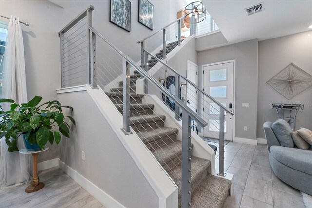 staircase with visible vents and baseboards