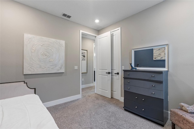 carpeted bedroom with visible vents and baseboards