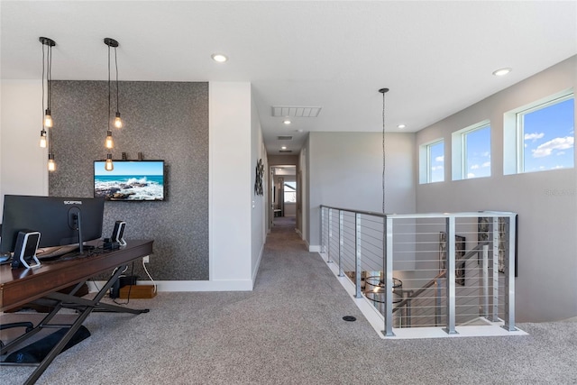 office featuring wallpapered walls, visible vents, baseboards, an accent wall, and carpet floors