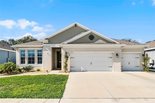 view of front of house featuring a garage and a front yard