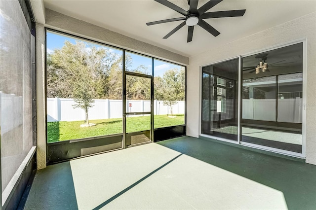 unfurnished sunroom with ceiling fan