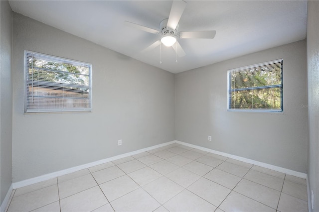 spare room featuring ceiling fan and light tile patterned floors