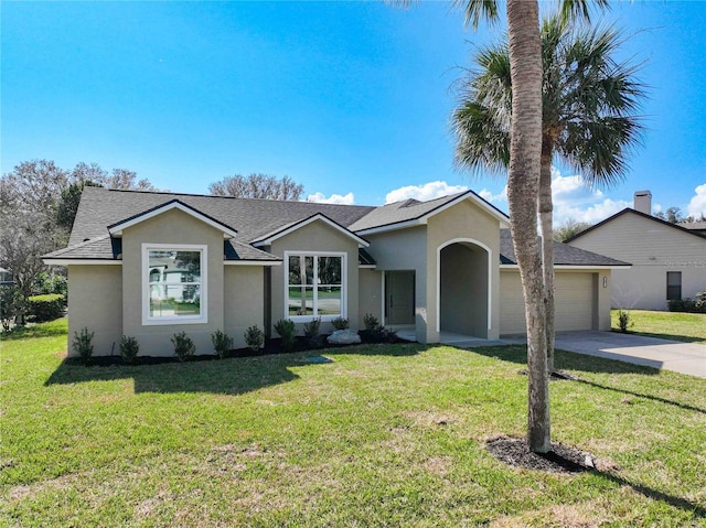 single story home featuring a garage and a front lawn