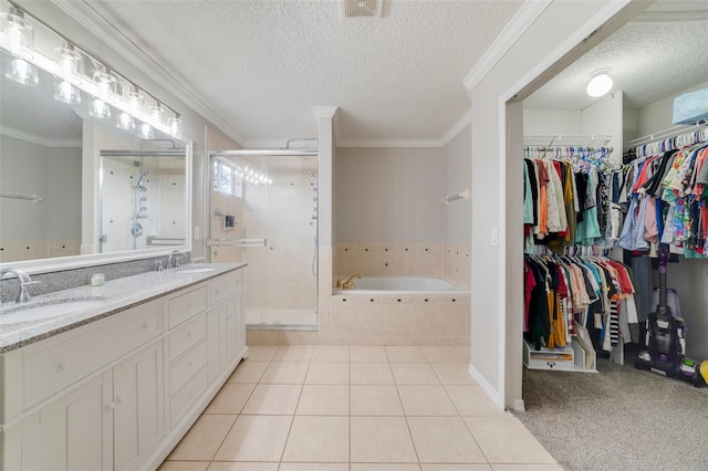 bathroom featuring a garden tub, a shower stall, ornamental molding, and a sink