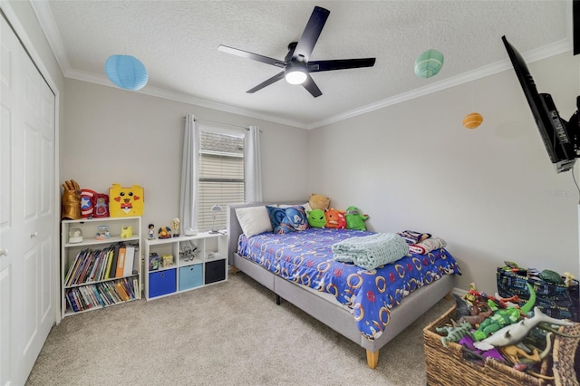 bedroom with light carpet, ceiling fan, a textured ceiling, crown molding, and a closet