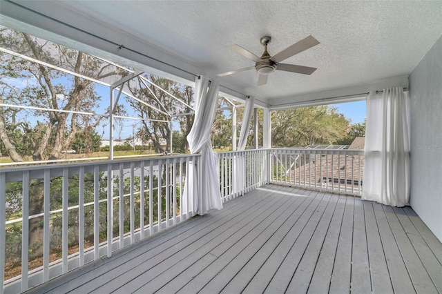 unfurnished sunroom featuring ceiling fan