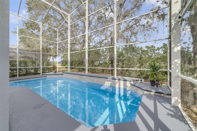 outdoor pool with glass enclosure and a patio