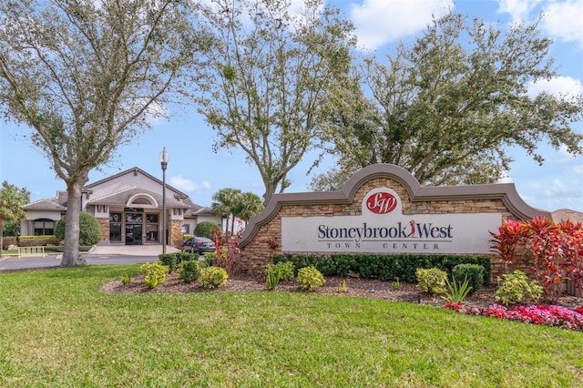 community sign featuring a lawn