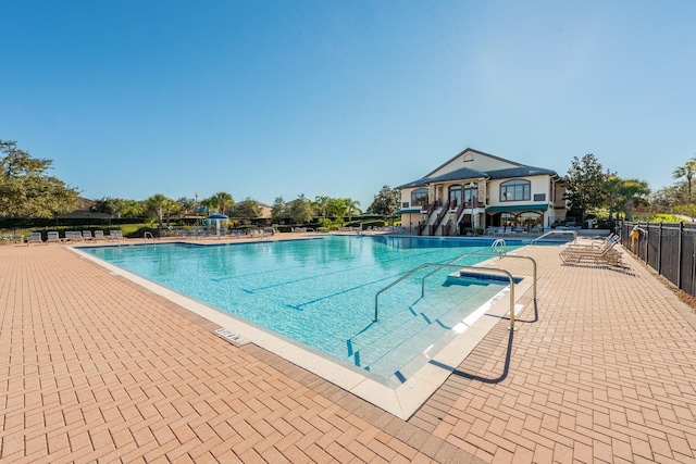 pool with fence and a patio