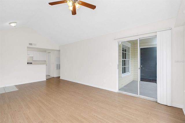 unfurnished living room featuring ceiling fan, vaulted ceiling, and light wood-type flooring