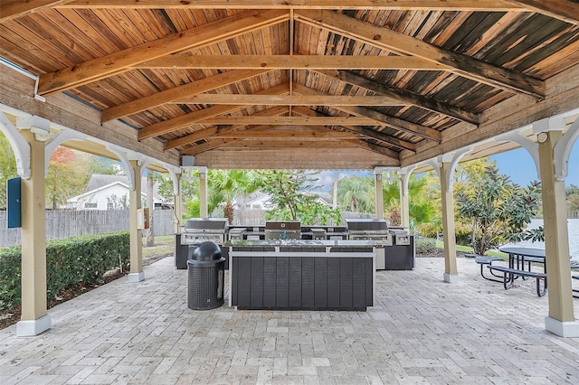 view of patio / terrace featuring a gazebo, grilling area, and exterior kitchen