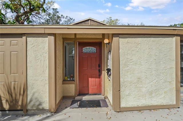 view of exterior entry with stucco siding