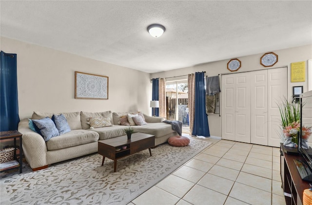 living room featuring light tile patterned floors and a textured ceiling