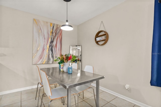 dining space with light tile patterned floors and baseboards