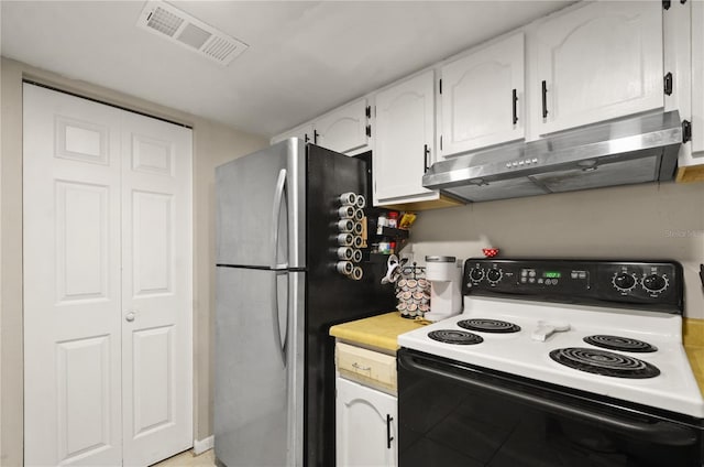 kitchen featuring under cabinet range hood, white cabinetry, visible vents, electric stove, and freestanding refrigerator