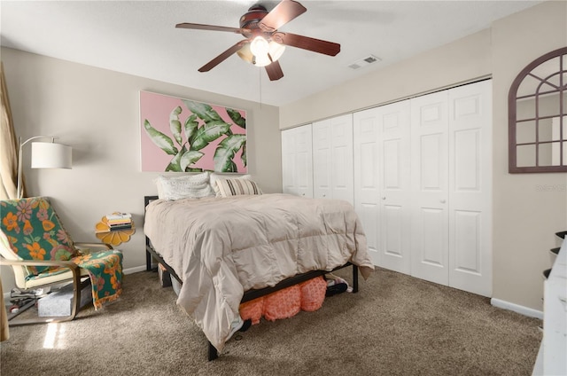 carpeted bedroom with a closet, visible vents, ceiling fan, and baseboards