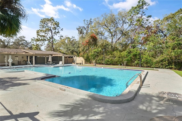 community pool with a patio area