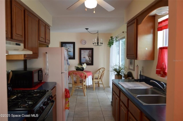 kitchen featuring sink, light tile patterned floors, ceiling fan with notable chandelier, and black appliances