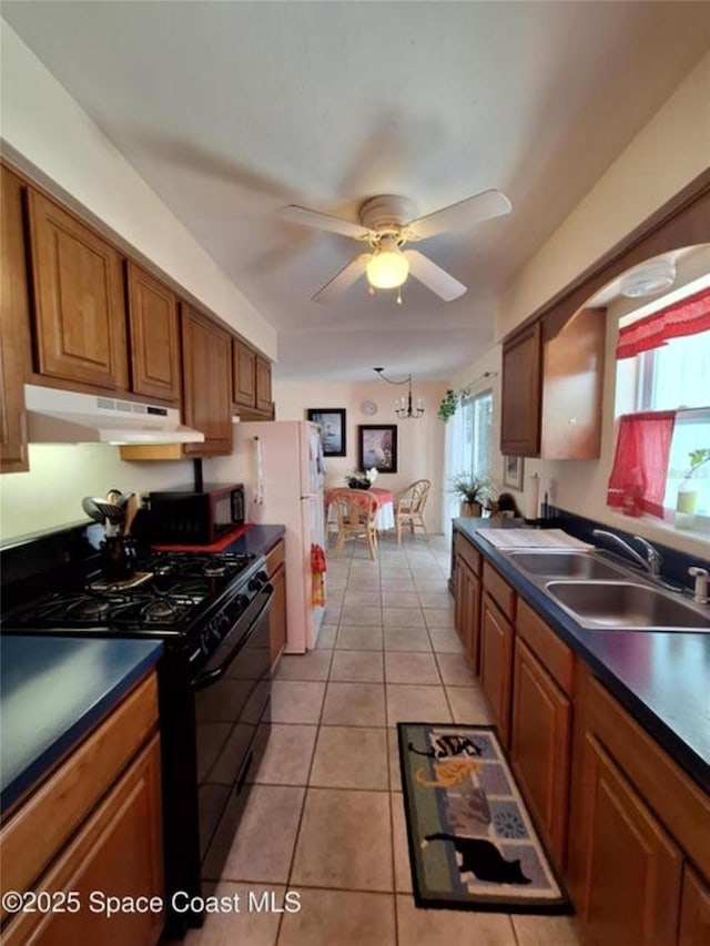 kitchen with light tile patterned flooring, ceiling fan, sink, and black appliances