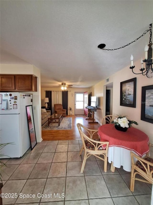 dining room with light tile patterned floors and a textured ceiling